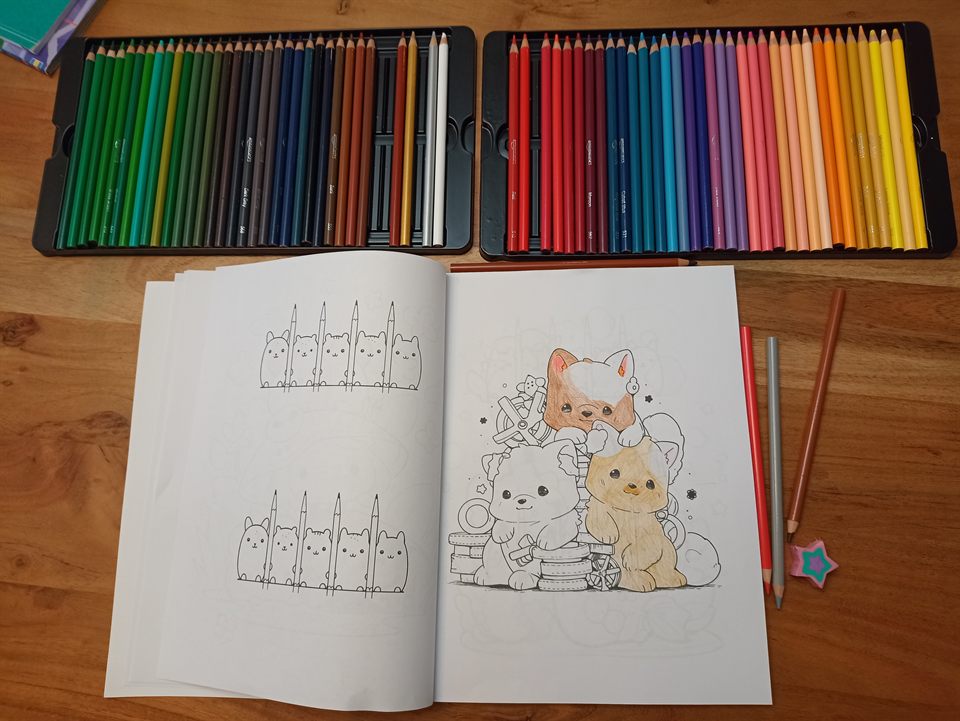 Kawaii Animals open on a table next to colored pencils, with a page being colored